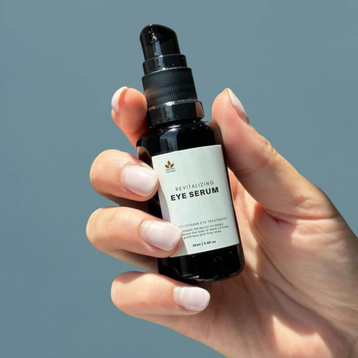 Hand holding a bottle of our Revitalizing Eye Serum - a powerful blend for refreshed, youthful eyes.for radiant, revitalized eyes."